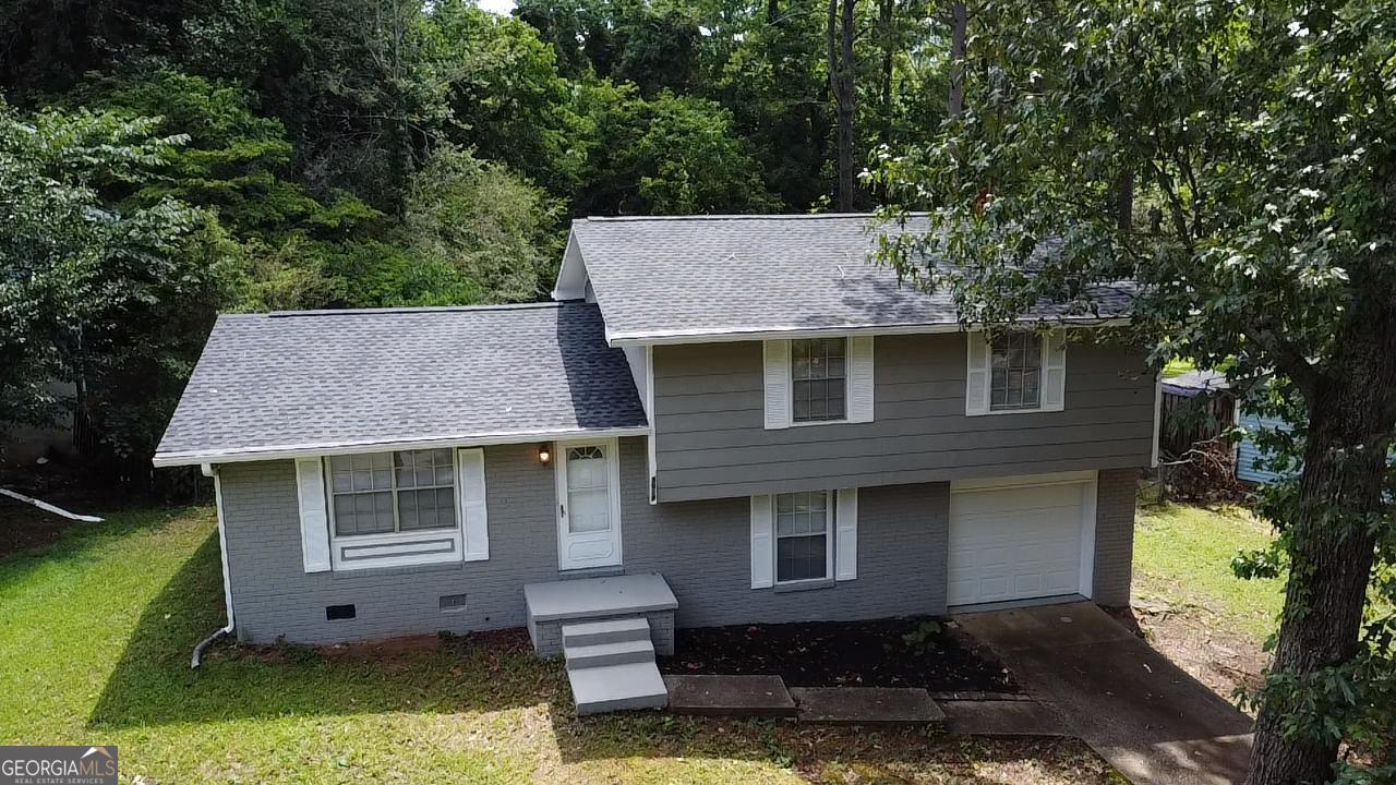 a aerial view of a house with a yard