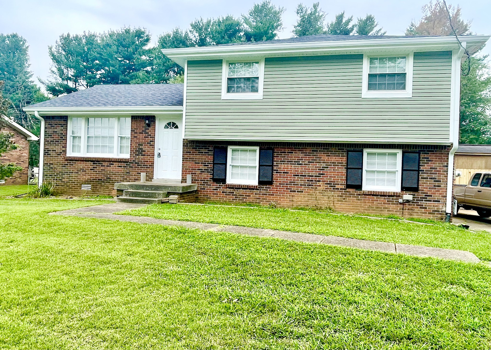 a front view of house with yard and outdoor seating