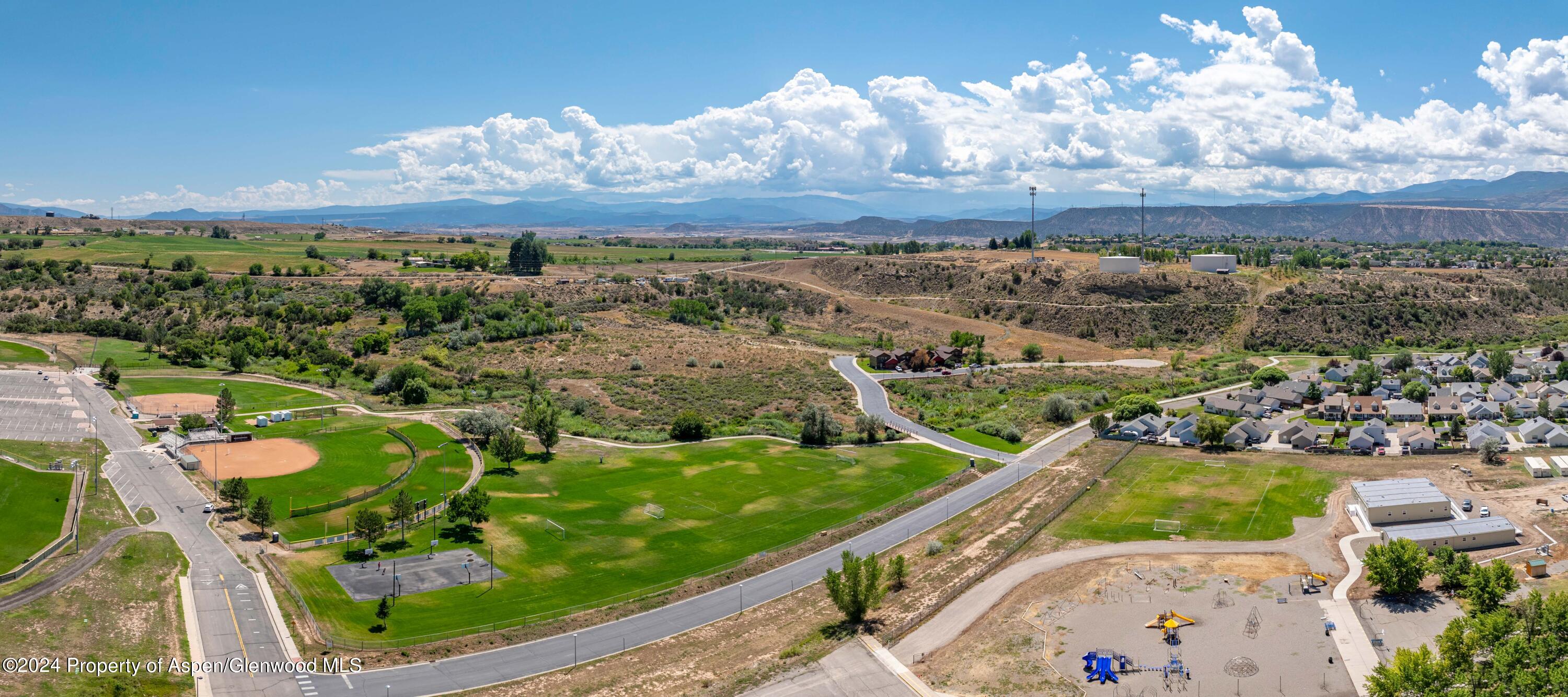 an aerial view of residential houses with outdoor space