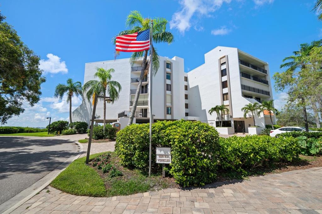 a front view of multi story residential apartment building with yard