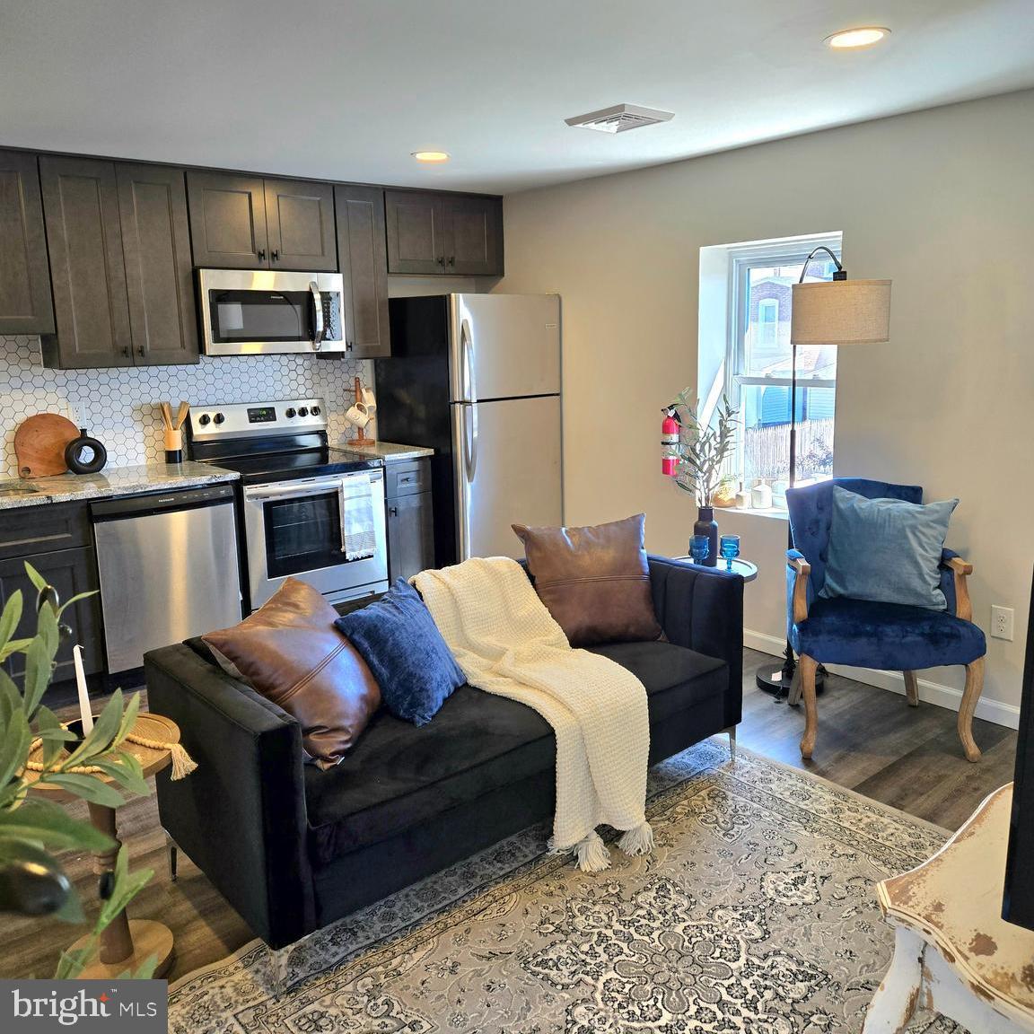 a bed room with a bed furniture and a kitchen