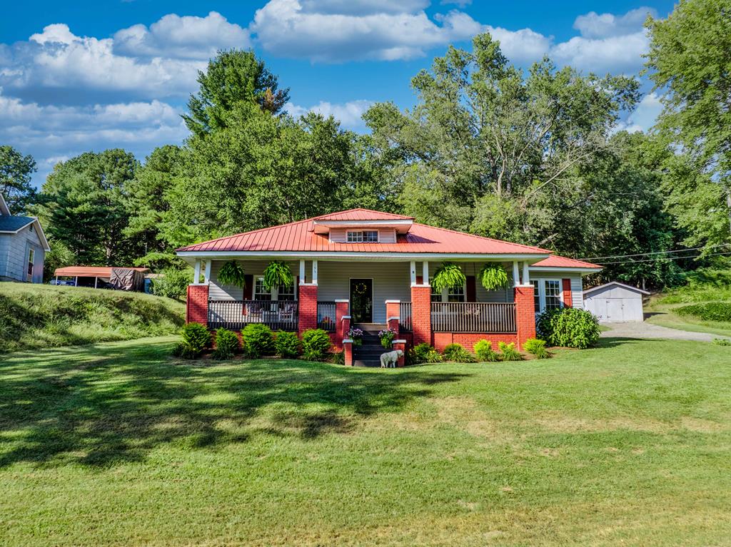 a front view of house with yard and green space