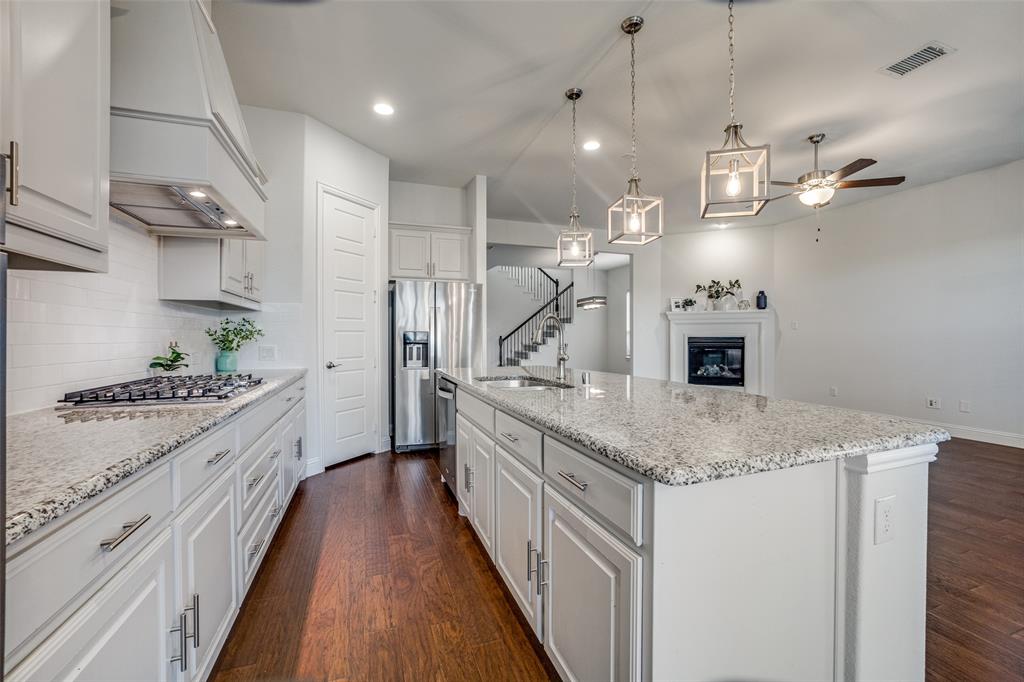 a large kitchen with stainless steel appliances granite countertop a lot of counter space