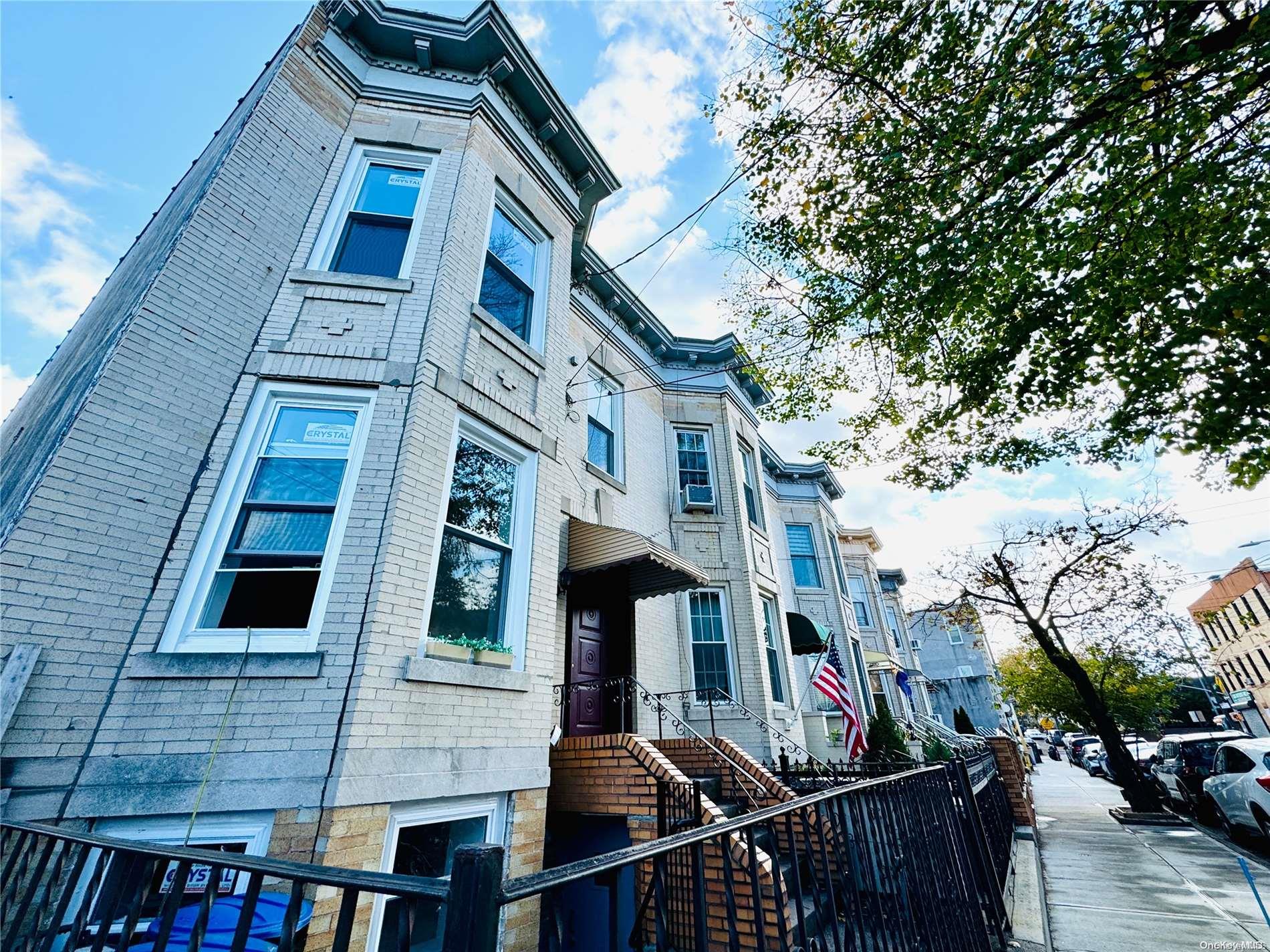 a front view of a building with lot of space and windows