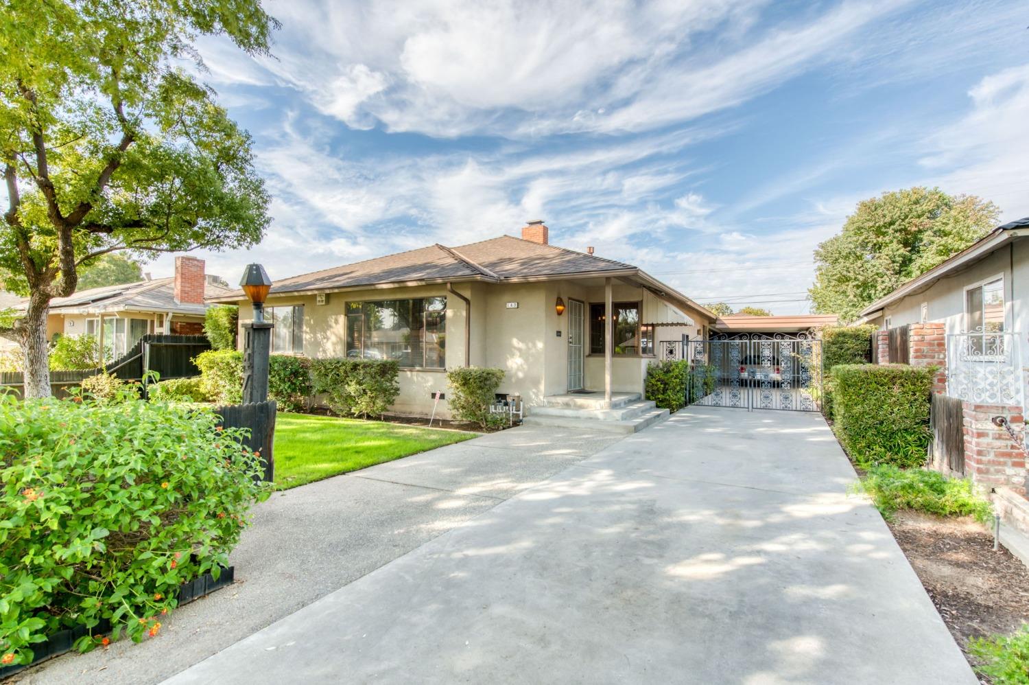 a front view of a house with a garden