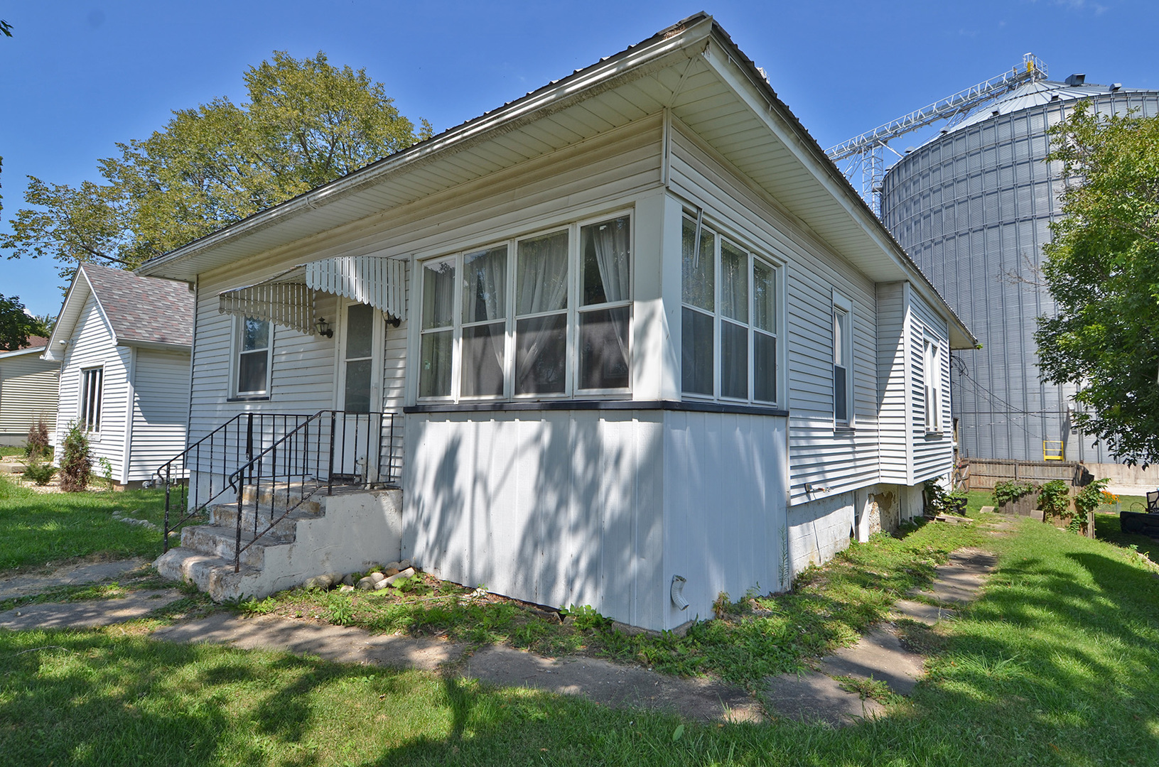 a view of a house with a small yard and wooden fence