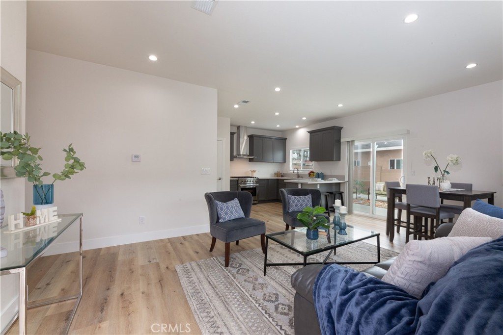 a living room with furniture and a dining room