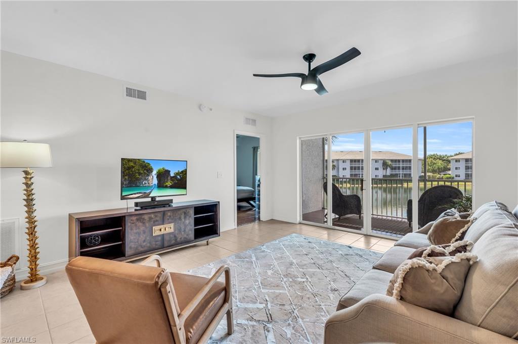 Tiled living room featuring ceiling fan