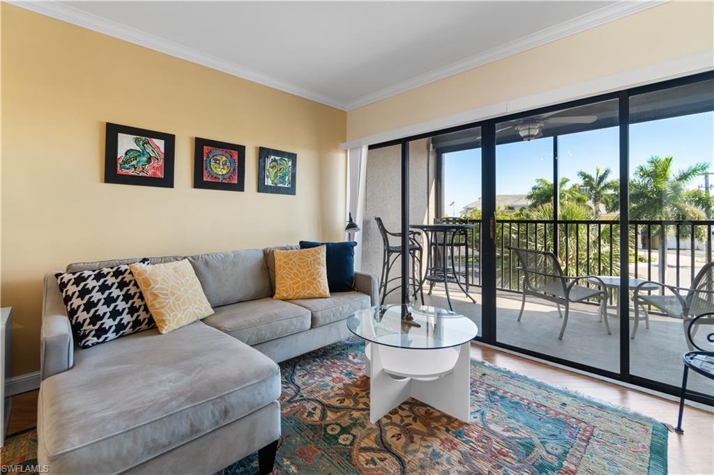 a living room with furniture and a floor to ceiling window