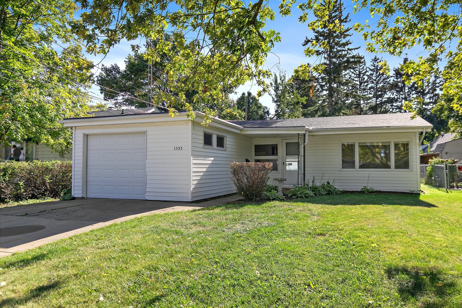 a view of a house with a yard and garage