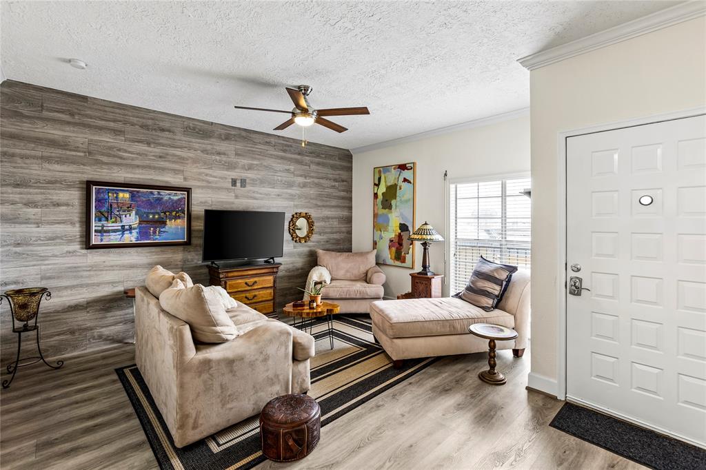 a living room with furniture wooden floor and a fireplace