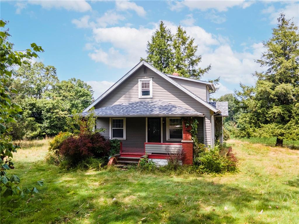 a front view of house with yard and green space