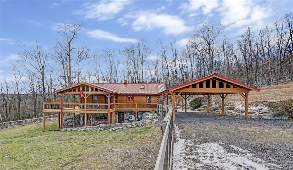 One-of-a-kind 3BD/2.5BTH Log Ranch Home w/ finished walk-out Lower Level.