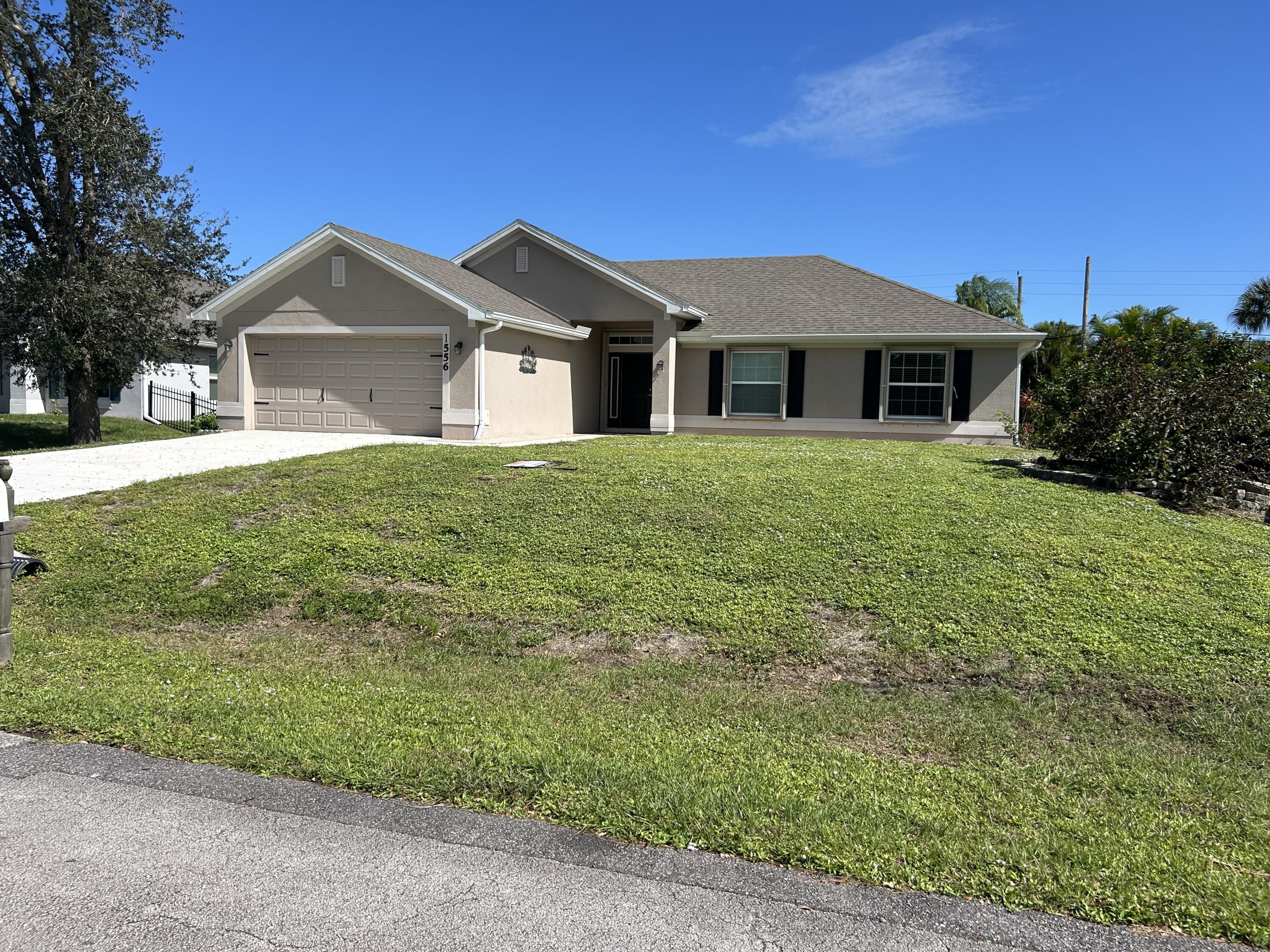 a front view of a house with yard