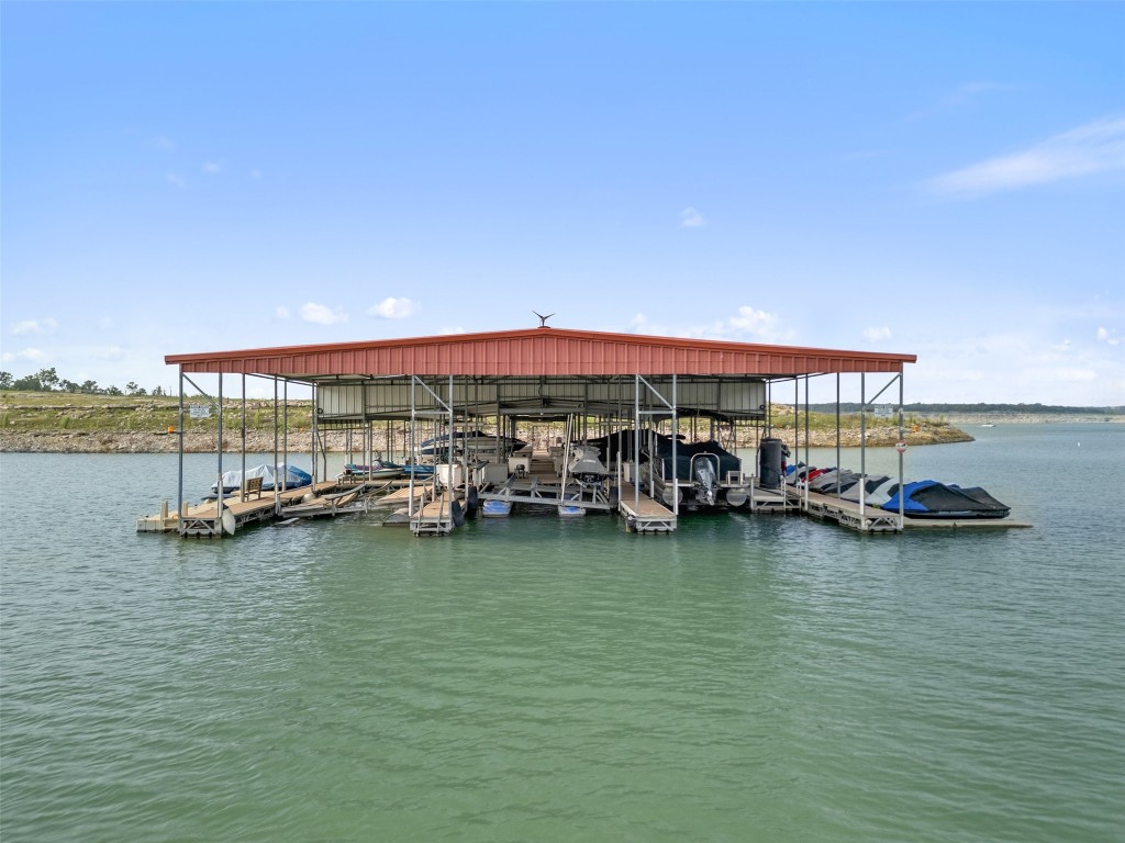 Community Private Dock w/ 28 ft long x 12 ft wide boat slip for this home + 2 dedicated jet ski spaces + swim up deck w/ latter & bench to enjoy lake life! Pic shows water level now on 5.21.24 access for HOA via courtesy water shuttle ride from Hurst Harbor, all included in Low Mo HOA fee...WOW the value for $375 per Mo.