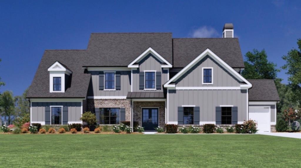 a front view of a house with a yard and trees