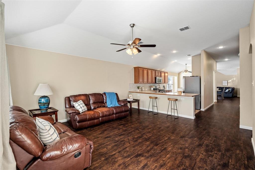 a living room with furniture and kitchen view