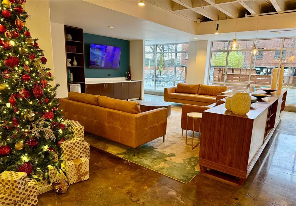 a living room with furniture a large window and a flat screen tv