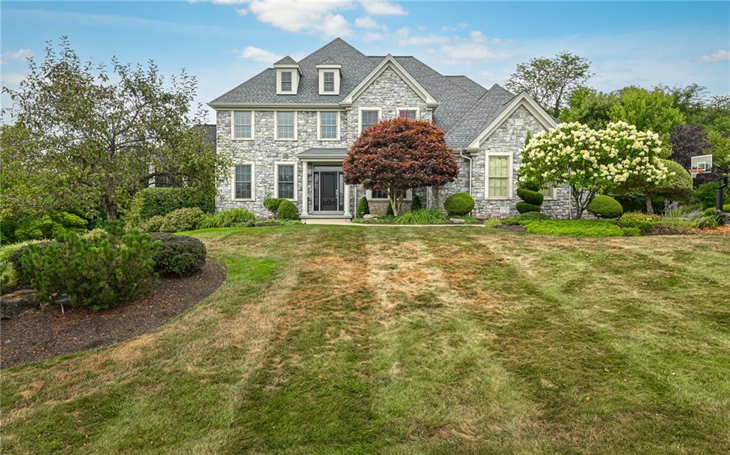 a front view of a house with a yard