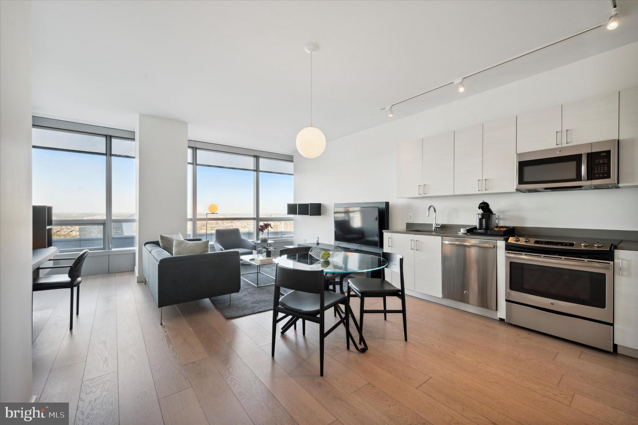 a kitchen with a table chairs stove and microwave