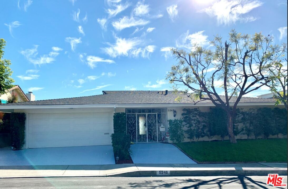 a view of a house with a tree