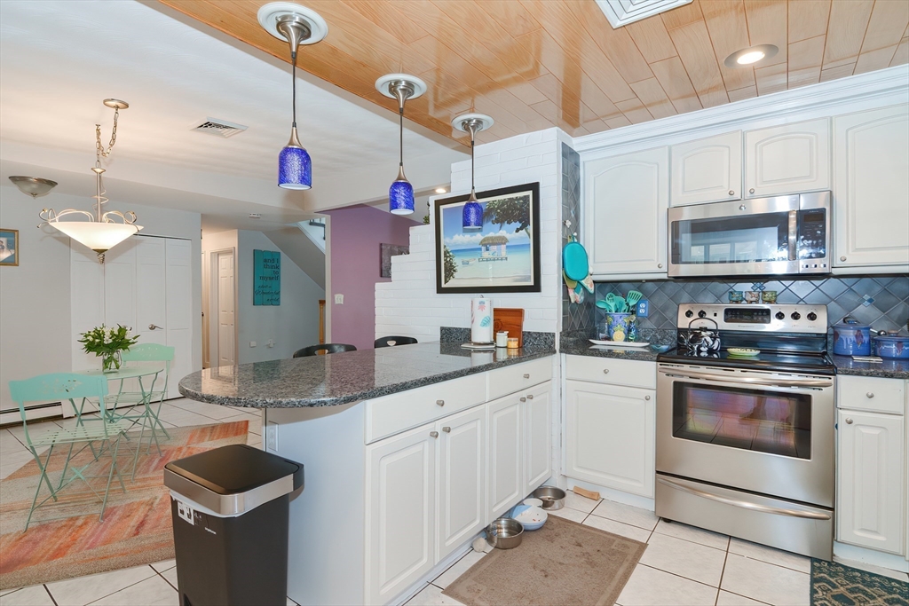 a kitchen with stainless steel appliances granite countertop a sink and cabinets