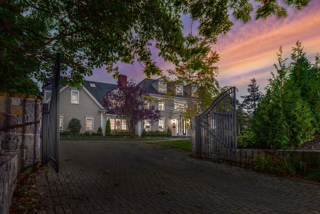 a front view of a house with a yard and tree s