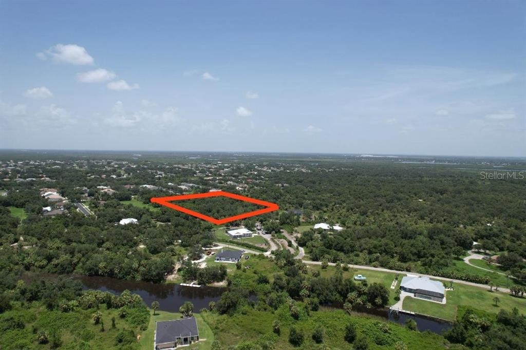 an aerial view of a houses with a yard