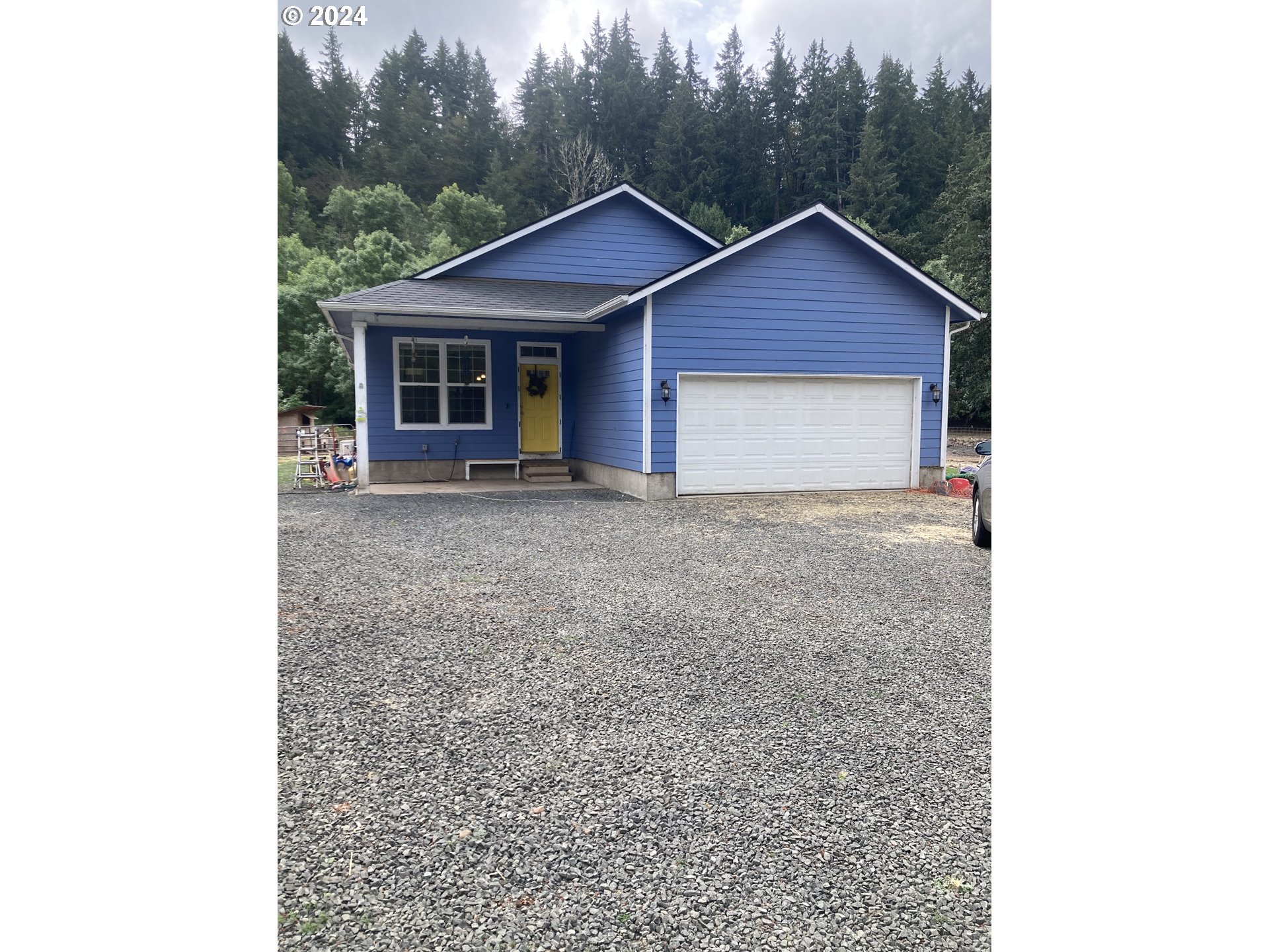 a view of a house with a yard and garage