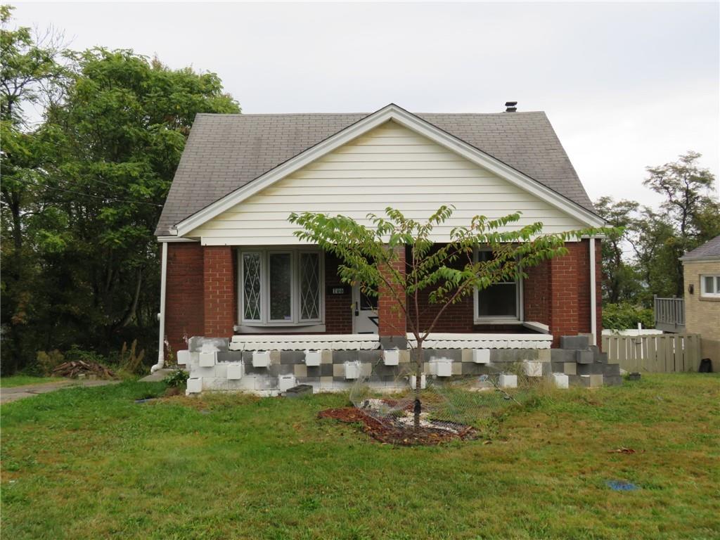 a front view of house with a garden and patio