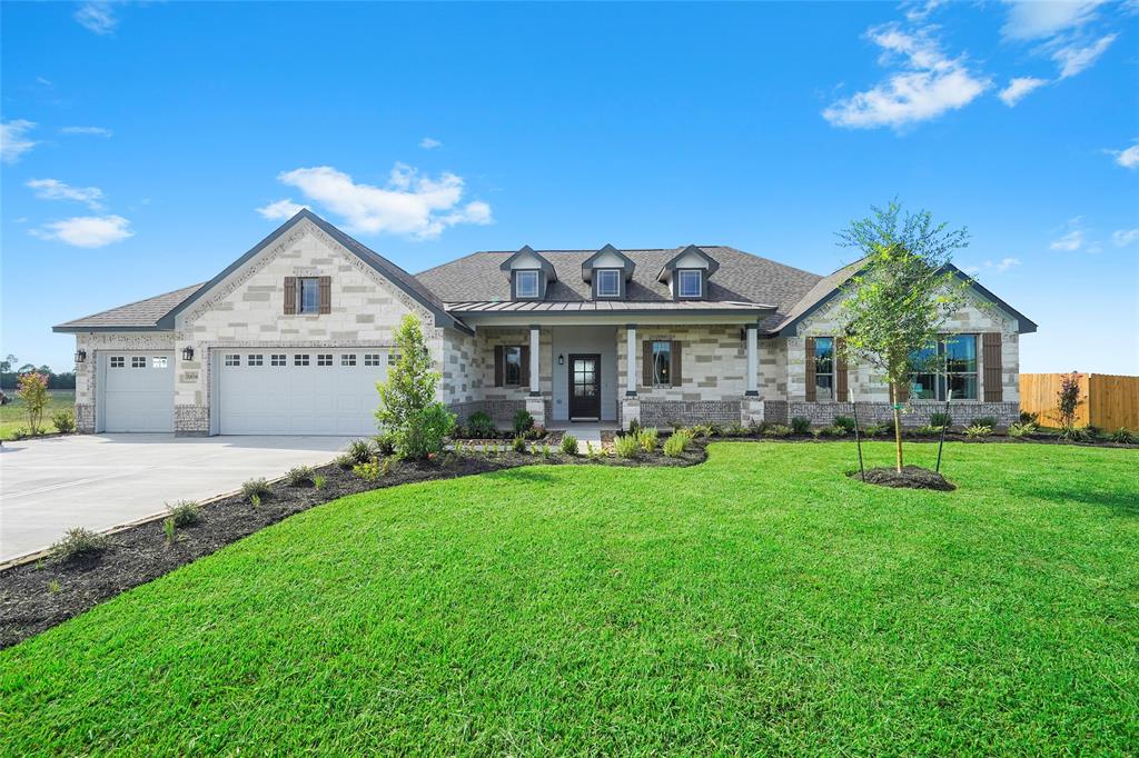 a front view of a house with a yard and porch