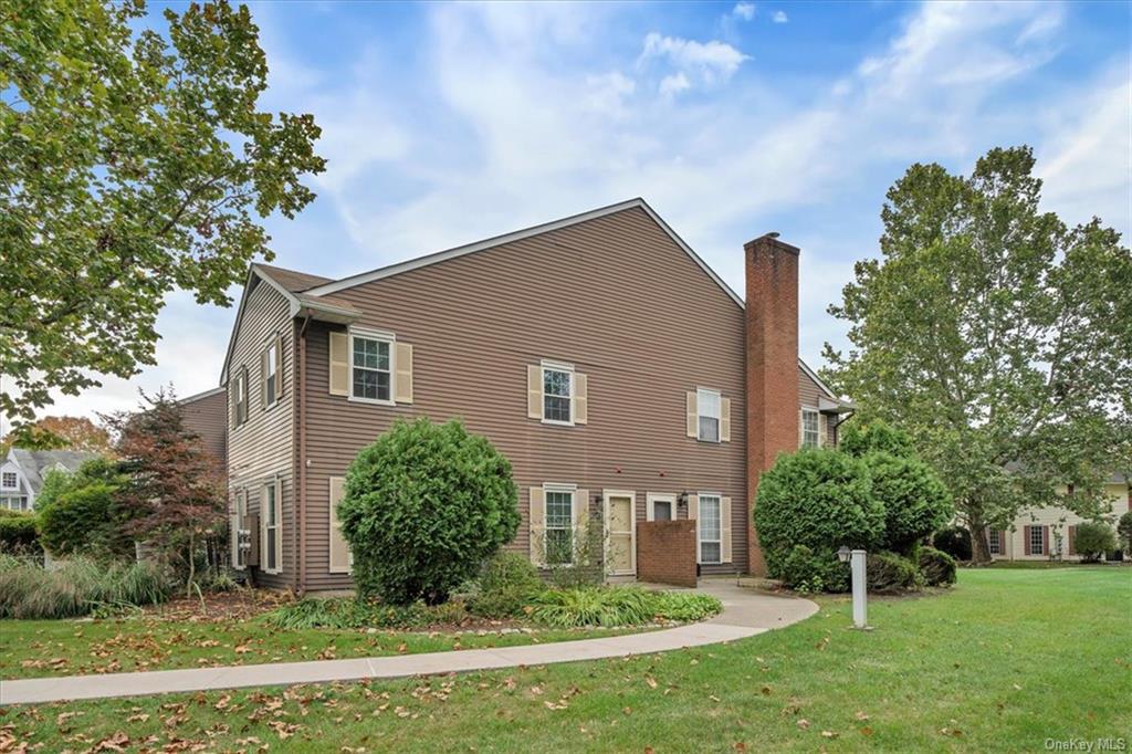 a house that has a tree in front of a white house