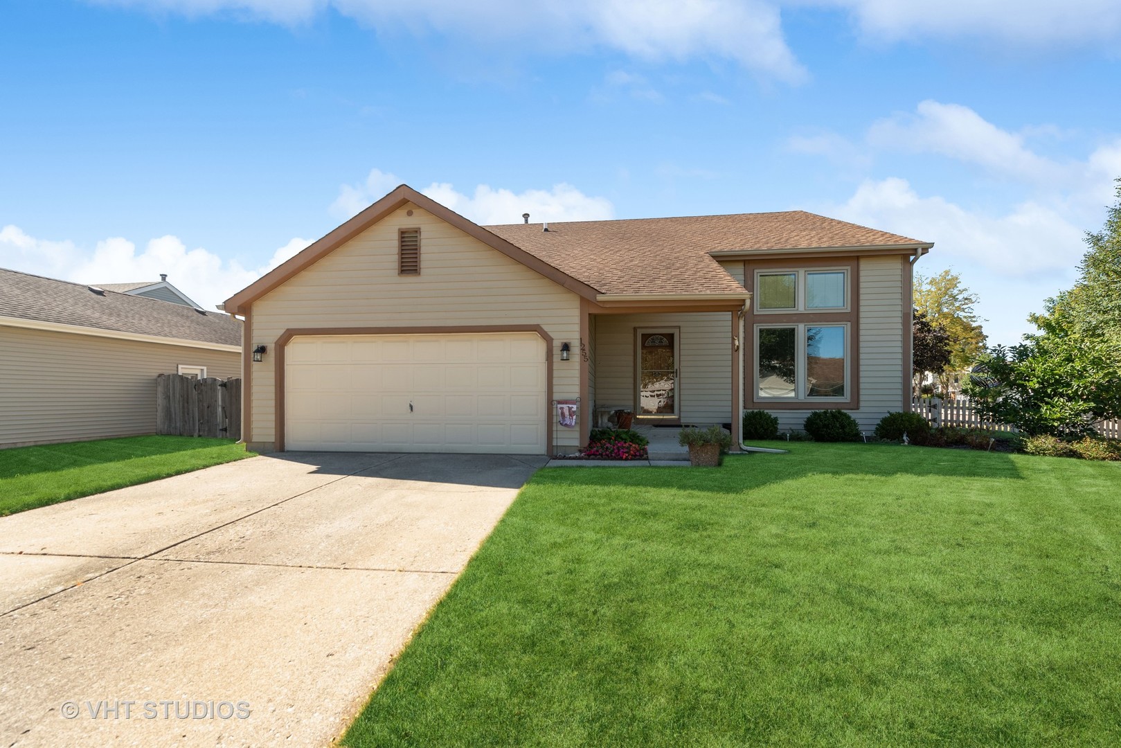 a front view of house with yard and green space