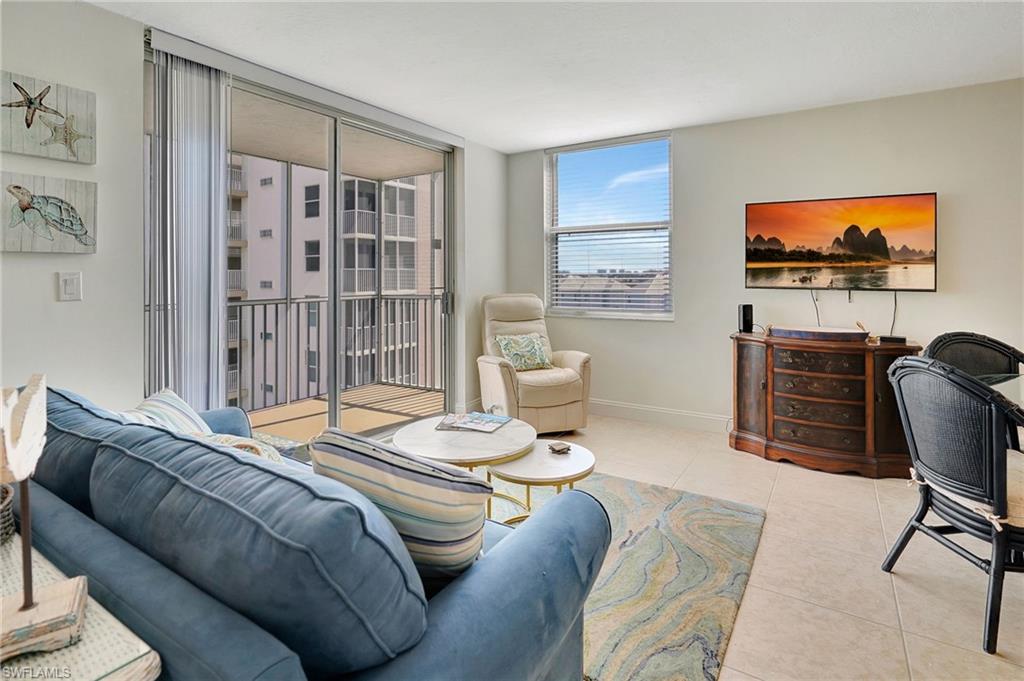 a bedroom with furniture and a flat screen tv