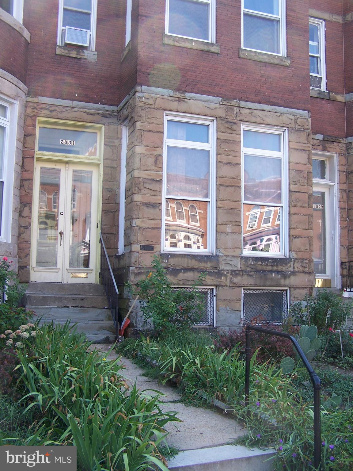 a view of a brick building next to a yard