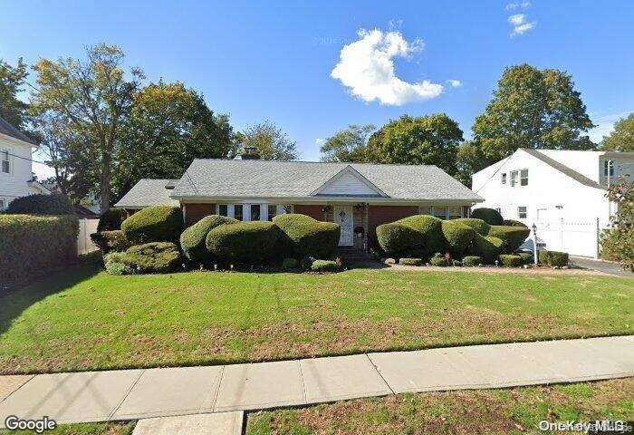 a view of a house with a backyard