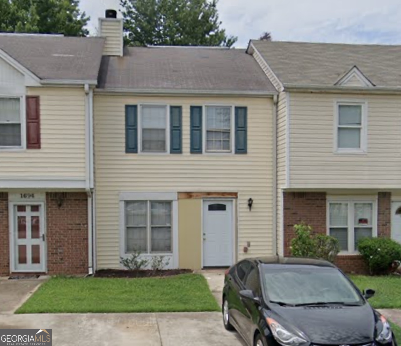 a front view of a house with a yard and table and chairs