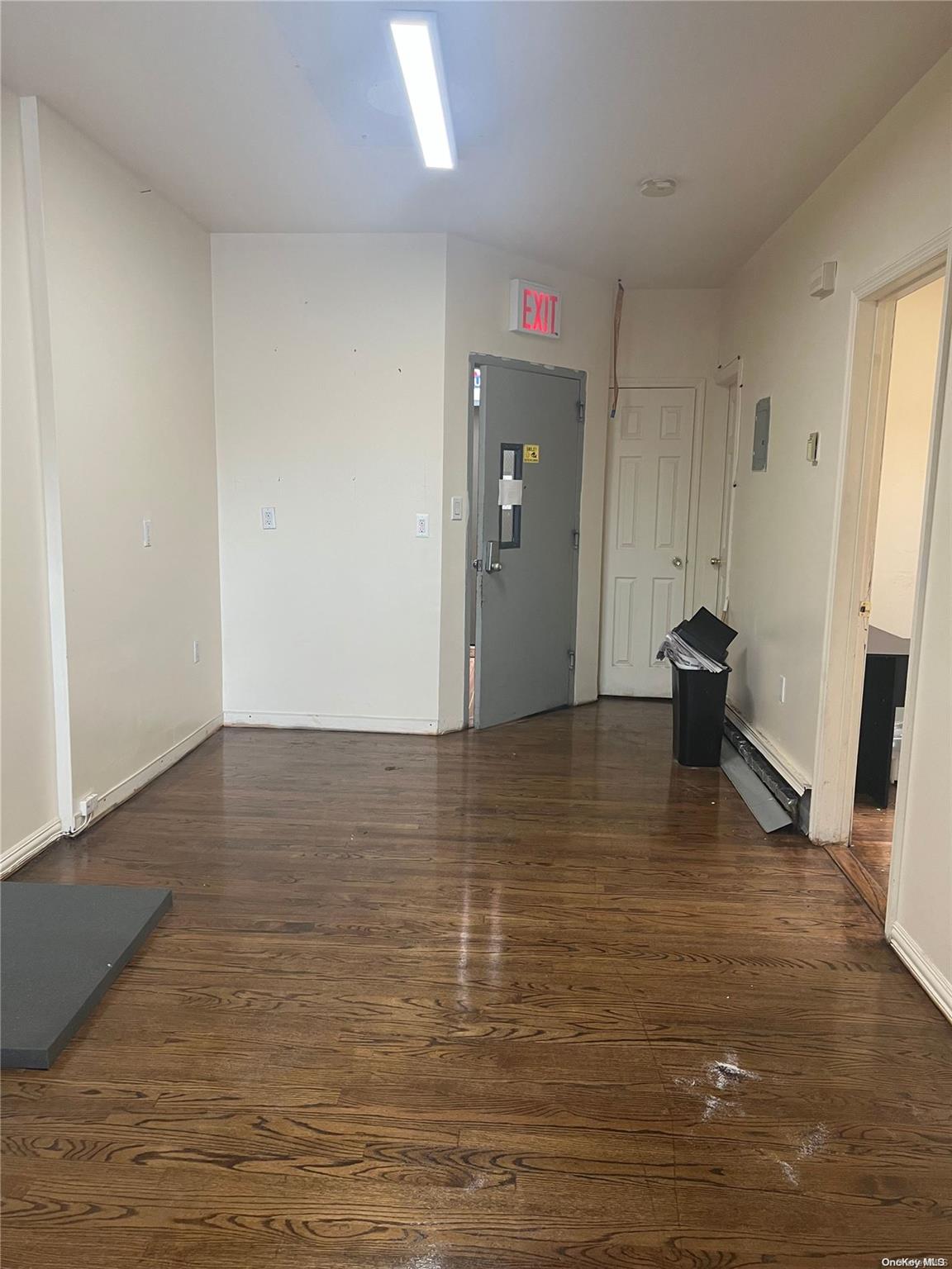 a view of empty room with wooden floor