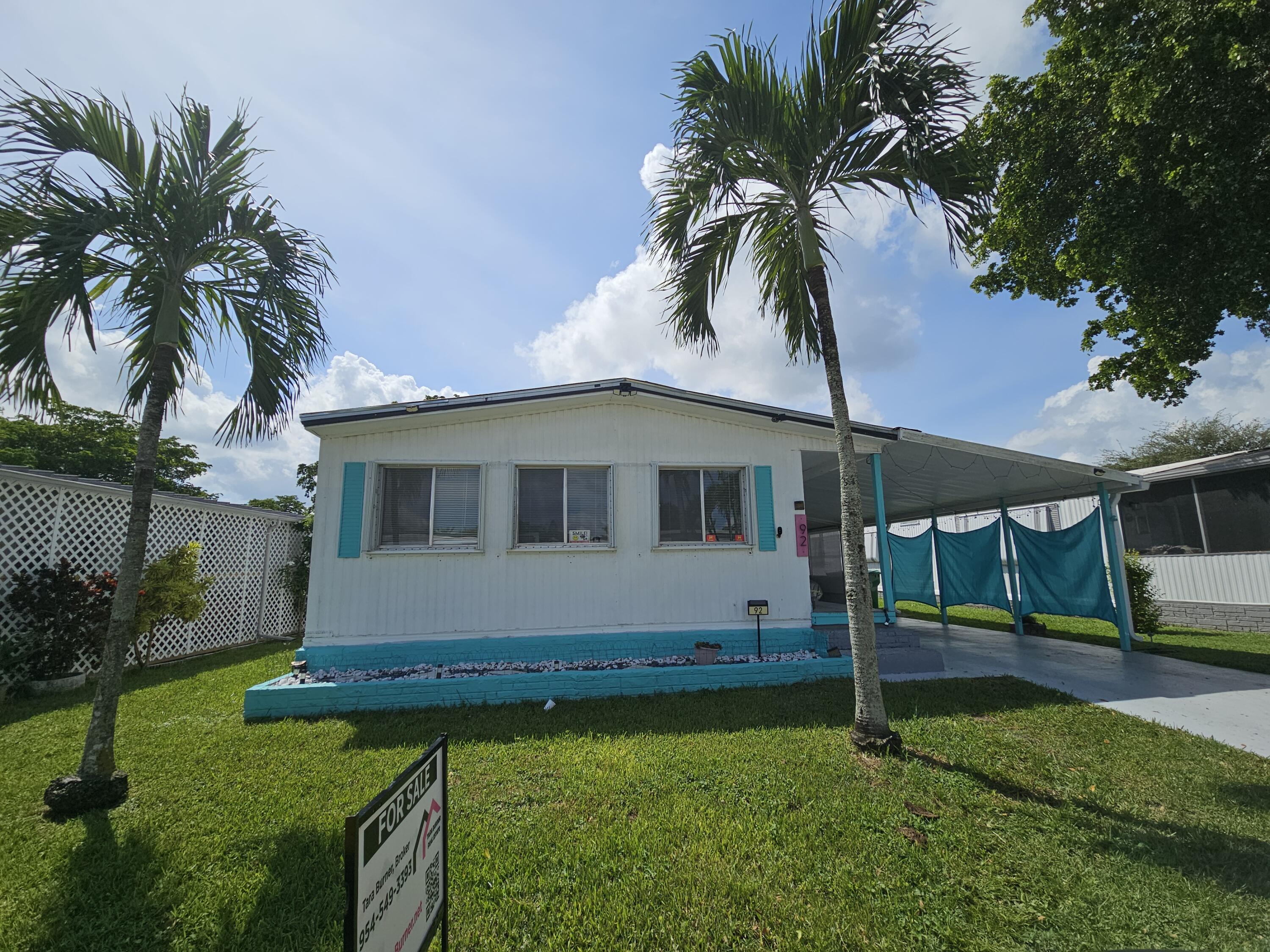 a front view of house with yard and outdoor seating