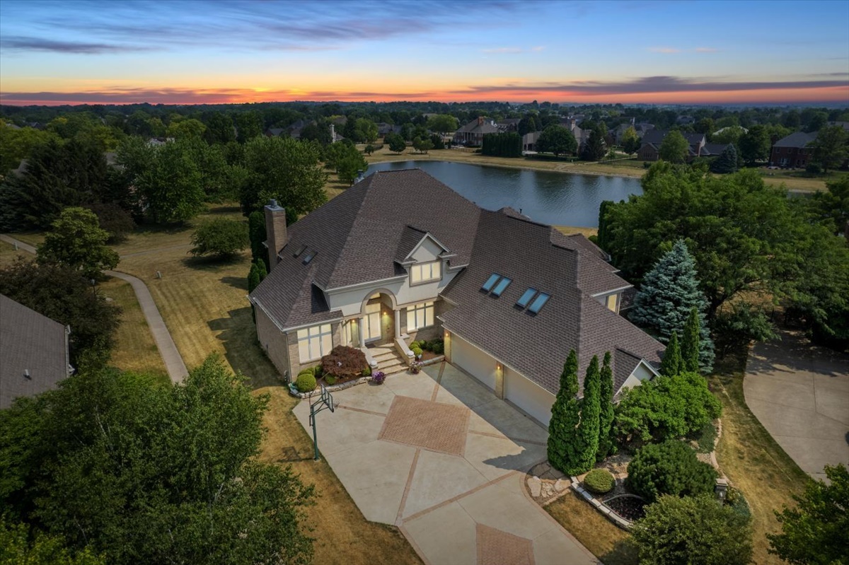 an aerial view of a house with a yard lake view and mountain view