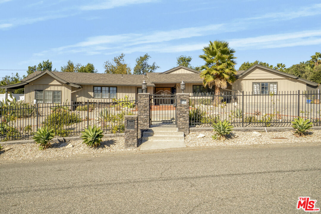 front view of a house with a bench