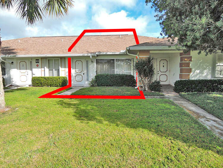 a view of a small space in front of a house with a small yard