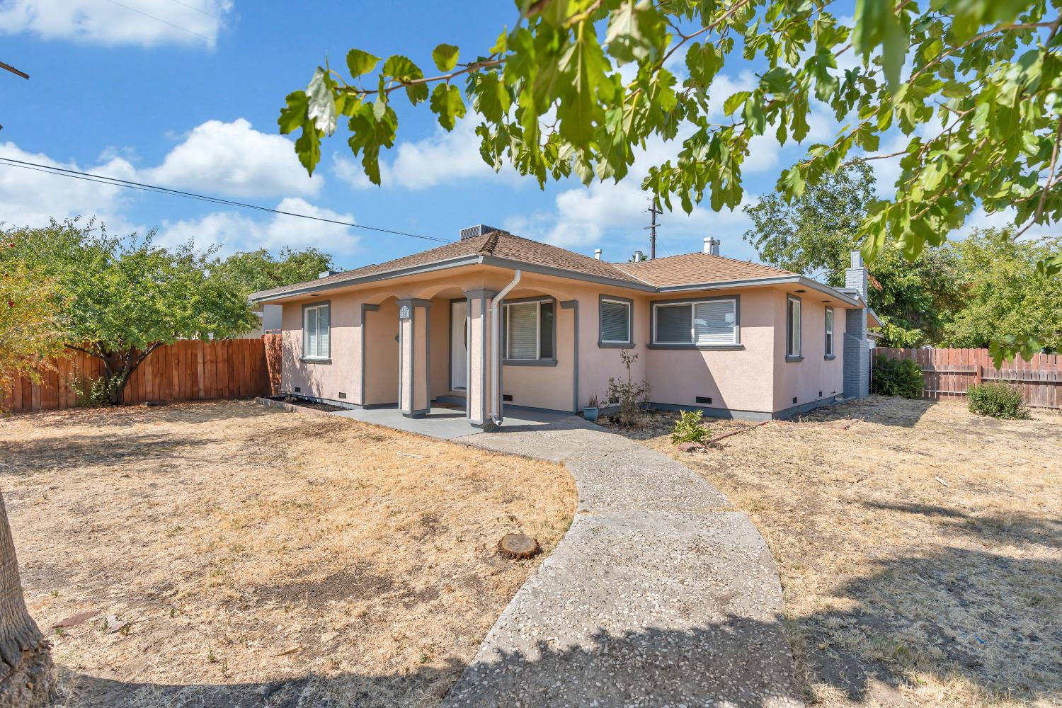 a view of a house with a tree in the background