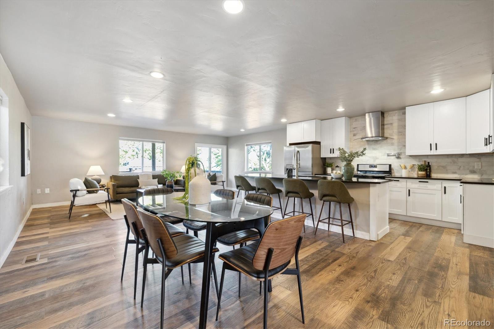 a view of a dining room with furniture and wooden floor