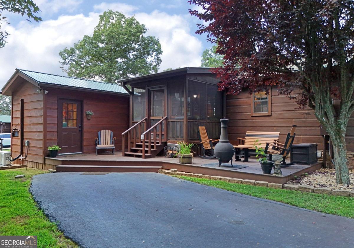 a view of a house with patio and a yard