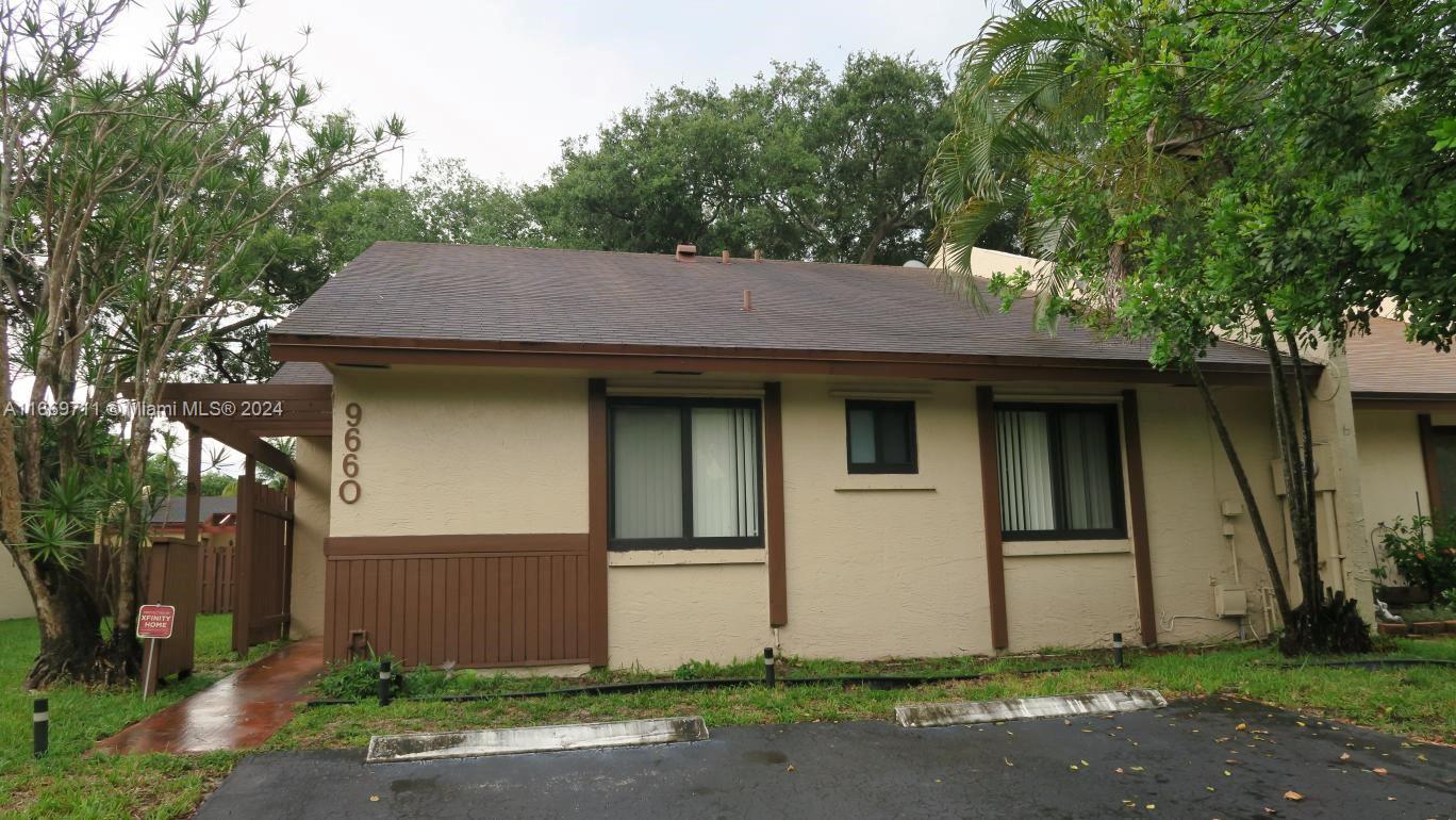 a house that has a tree in front of it