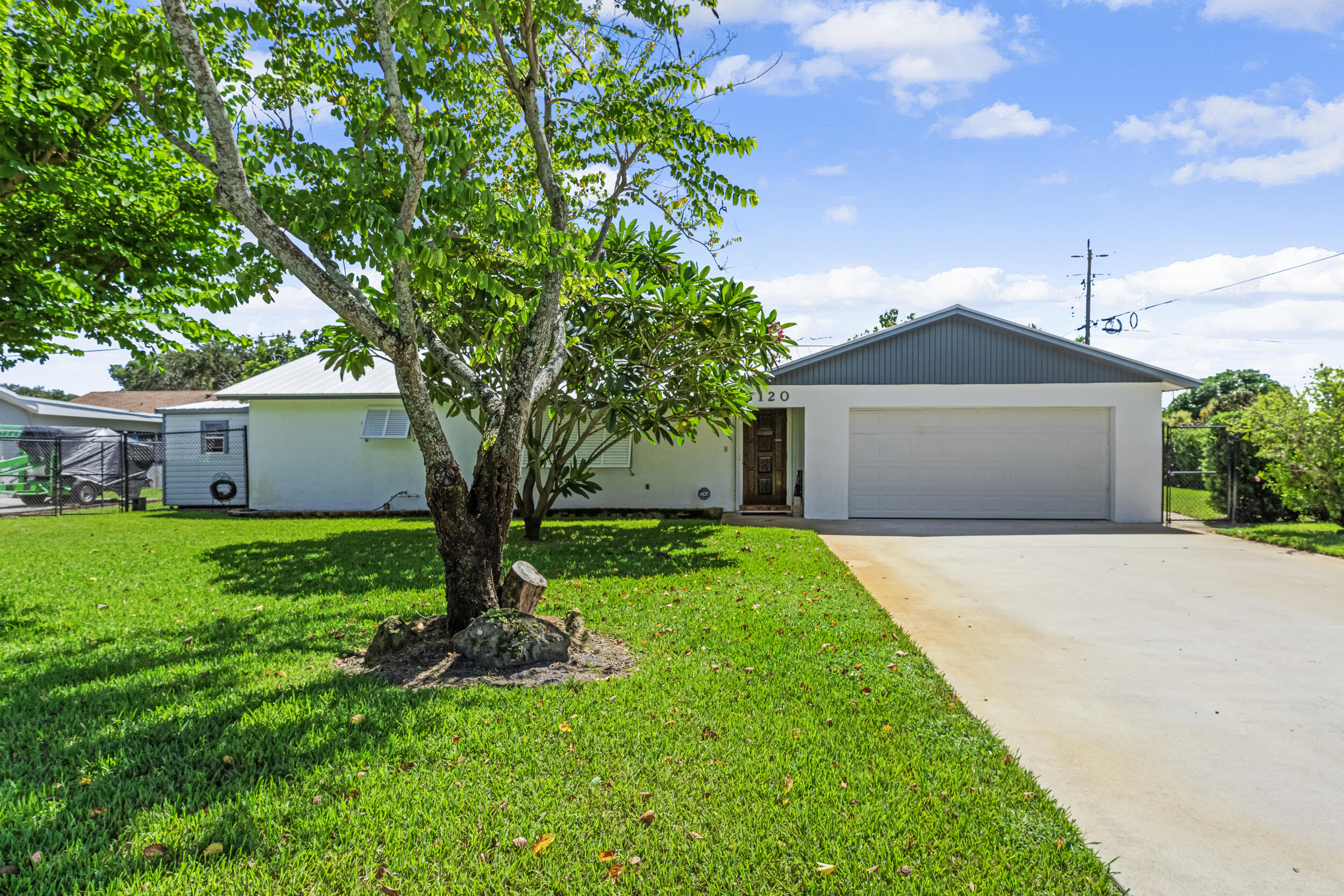 a front view of house with a garden