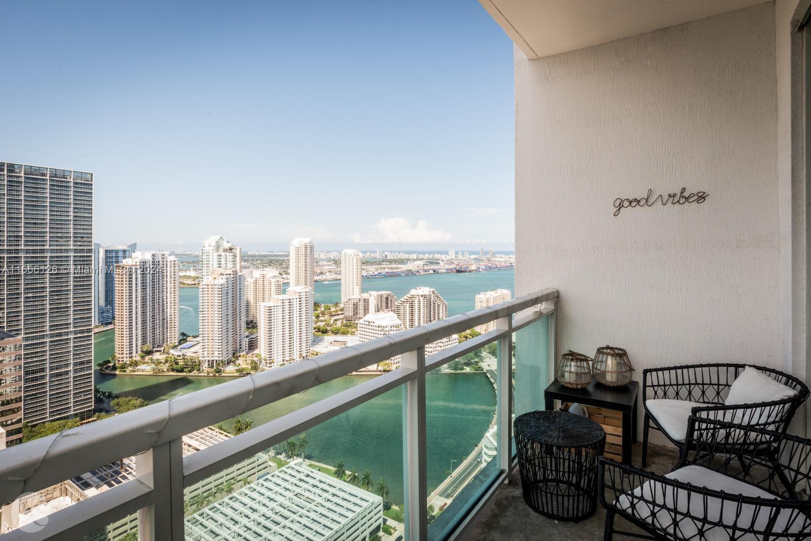 a view of a balcony with an outdoor seating