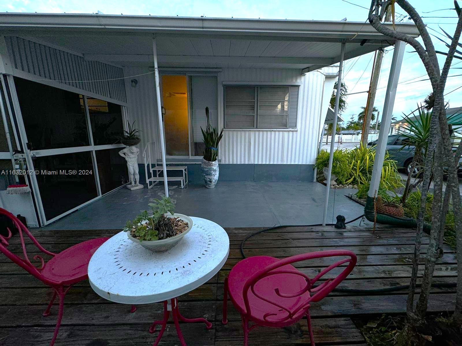 a dining room with furniture and a potted plant