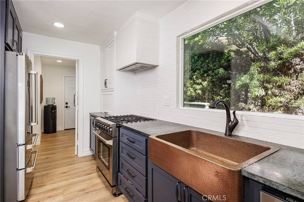 a kitchen that has a sink and a stove